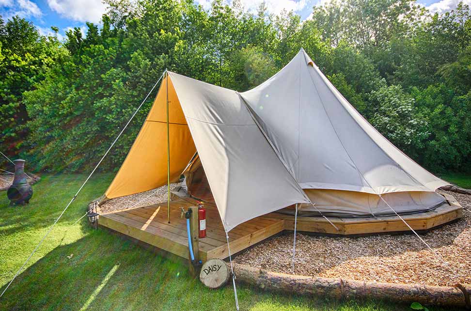 561b6d23cd80f07f6e828704_Outside-a-bell-tent-image
